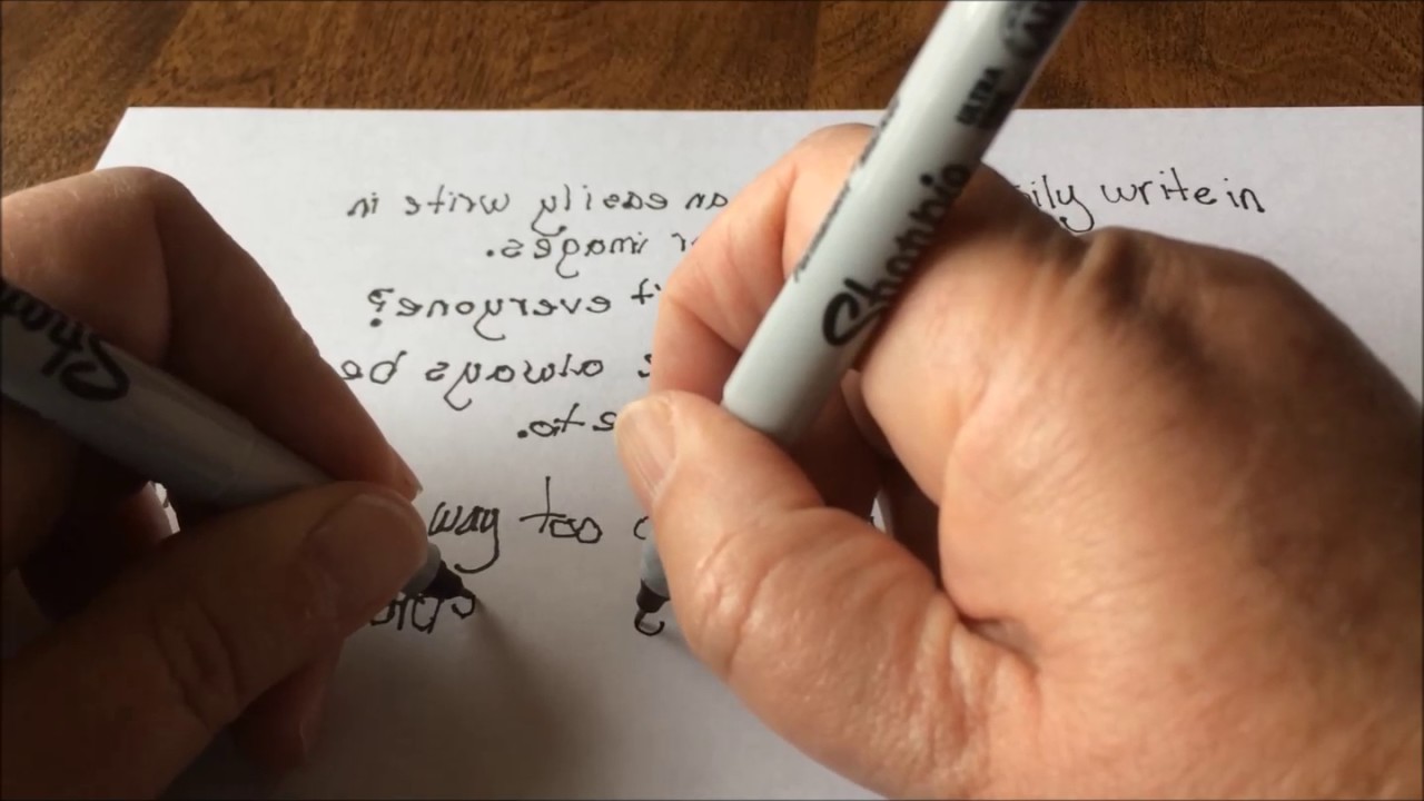 a person handwritting with both hands simultaneously