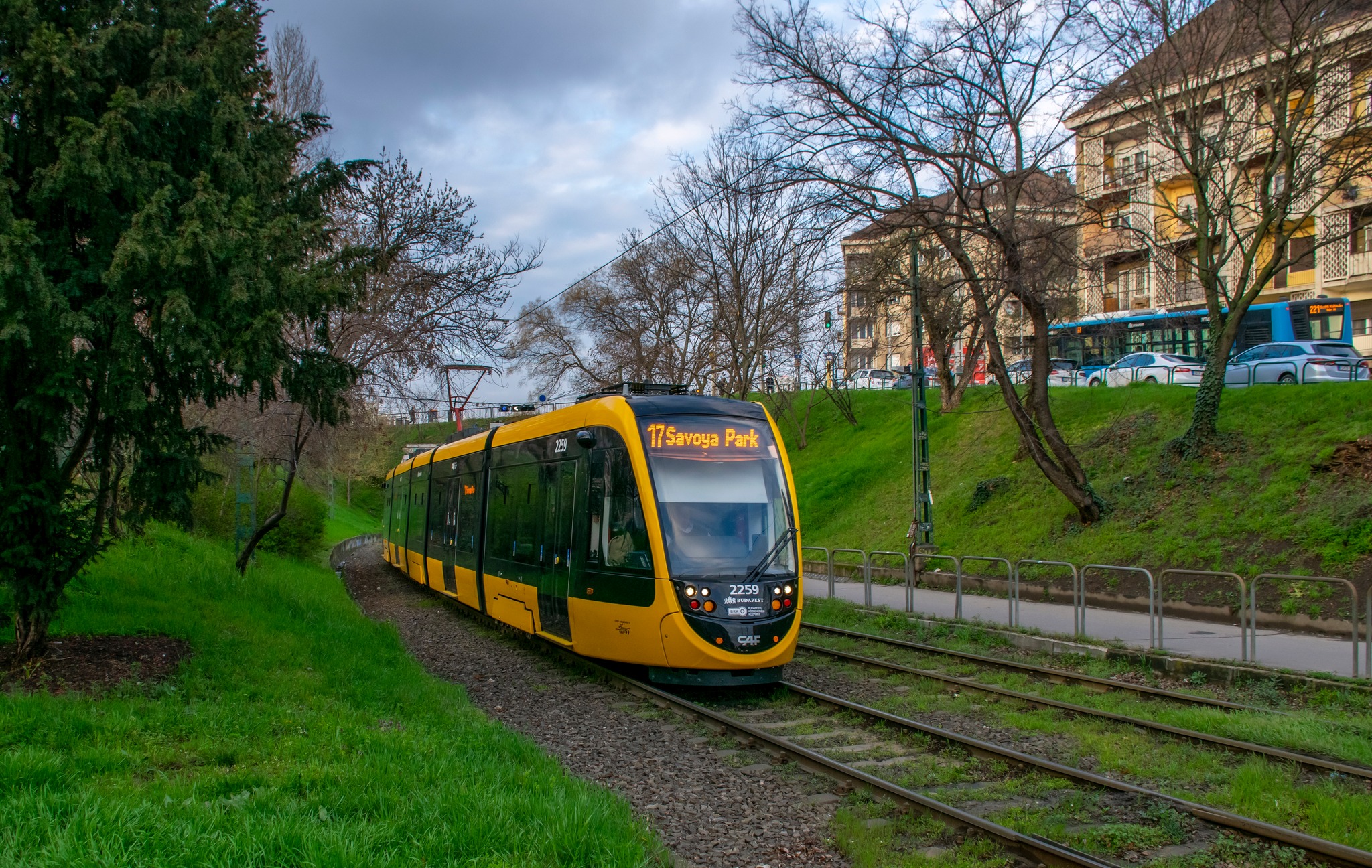 CAF Urbos 3 tram, lot of grass in the background