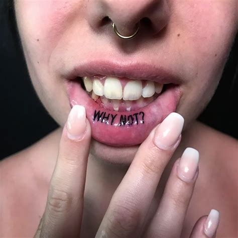 picture of a tattoo on an inner lip that says "why not"