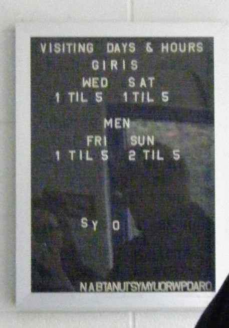 jail sign listing visiting hours for "men" and "girls"