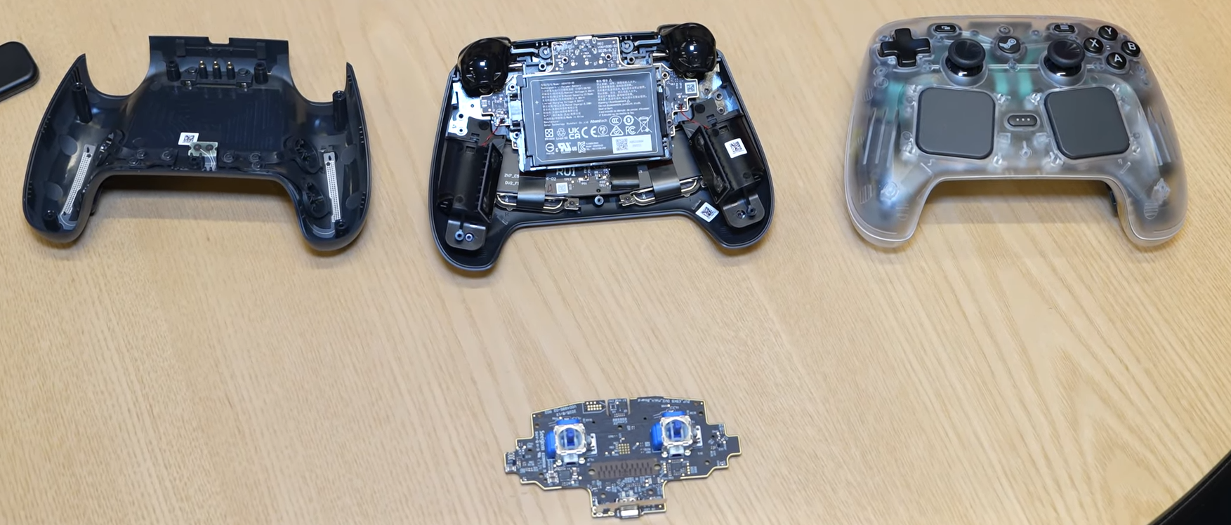 A disassembled Steam Controller with its bottom shell removed and its insides visible.