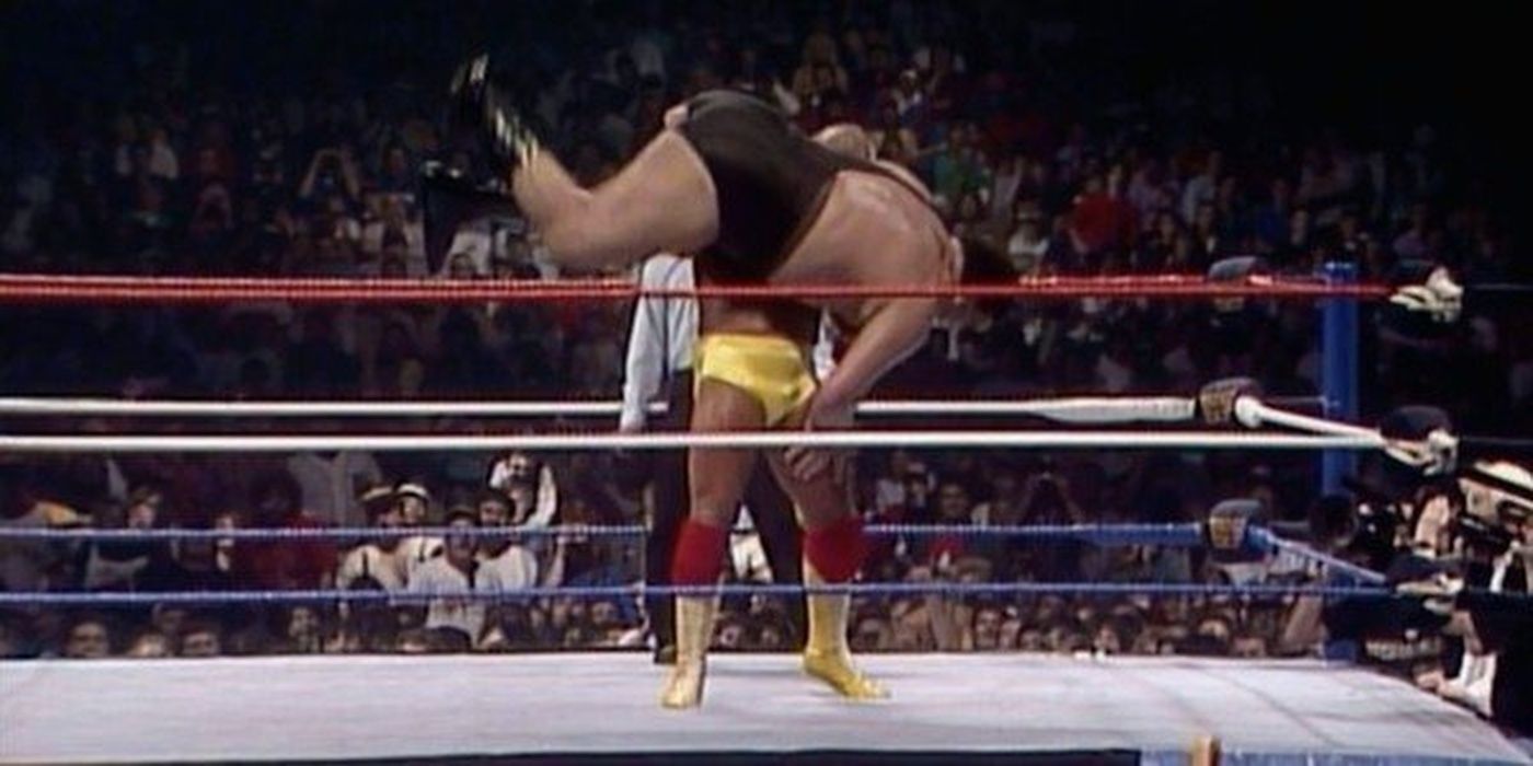 A screenshot of Hulk Hogan body slamming Andre the Giant during a wrestling match.