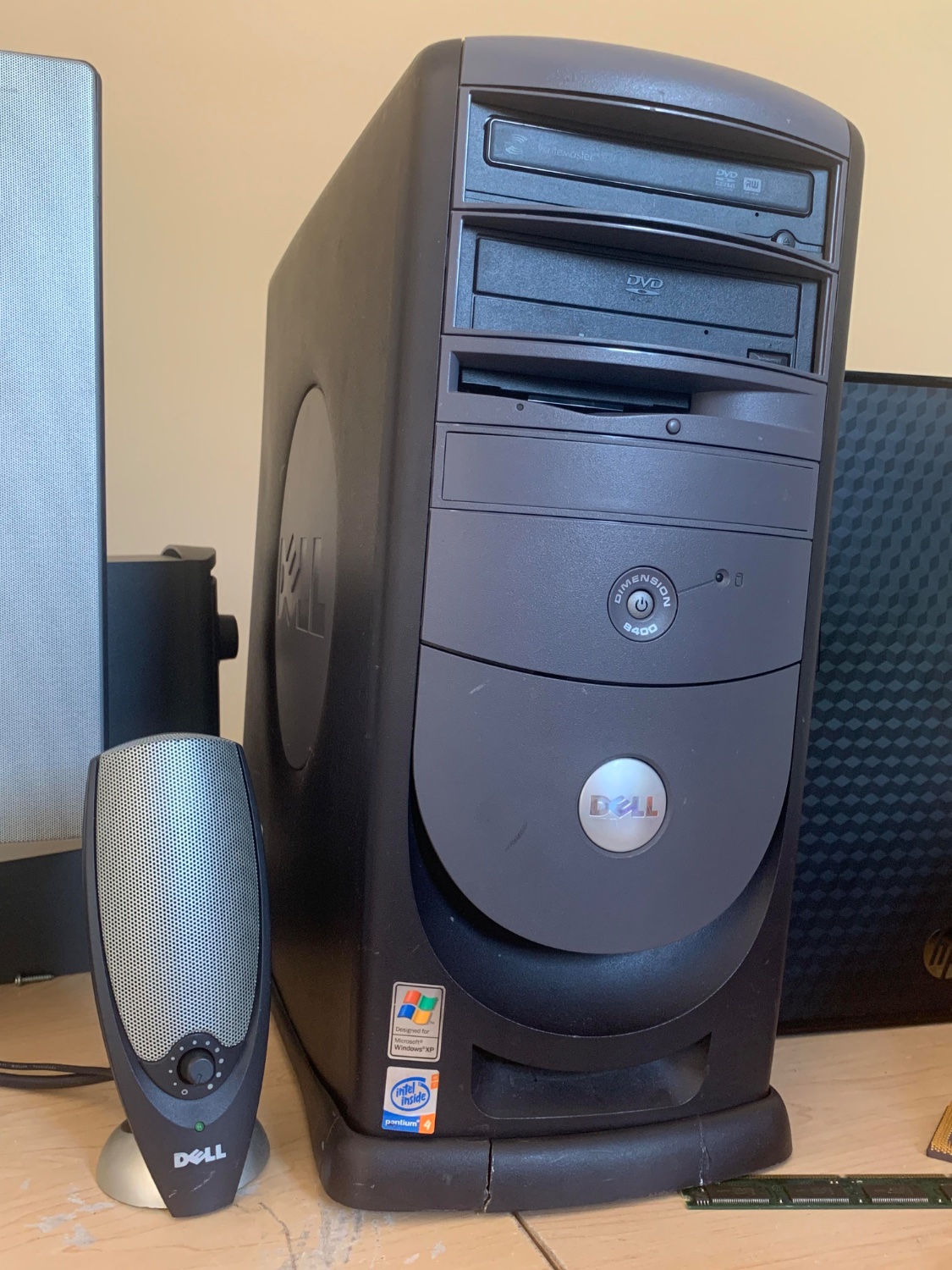 A circa 2004 Dell Dimension tower style desktop computer.  A Windows XP and Pentium 4 sticker can be seen.