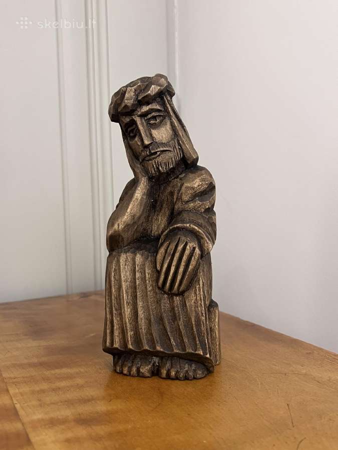 sculpture of a rūpintojėlis, a type of folklore depiction of Jesus as a beggar or a worrier