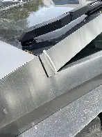 Reason enough to not buy American? Panel kept down with a zip tie...